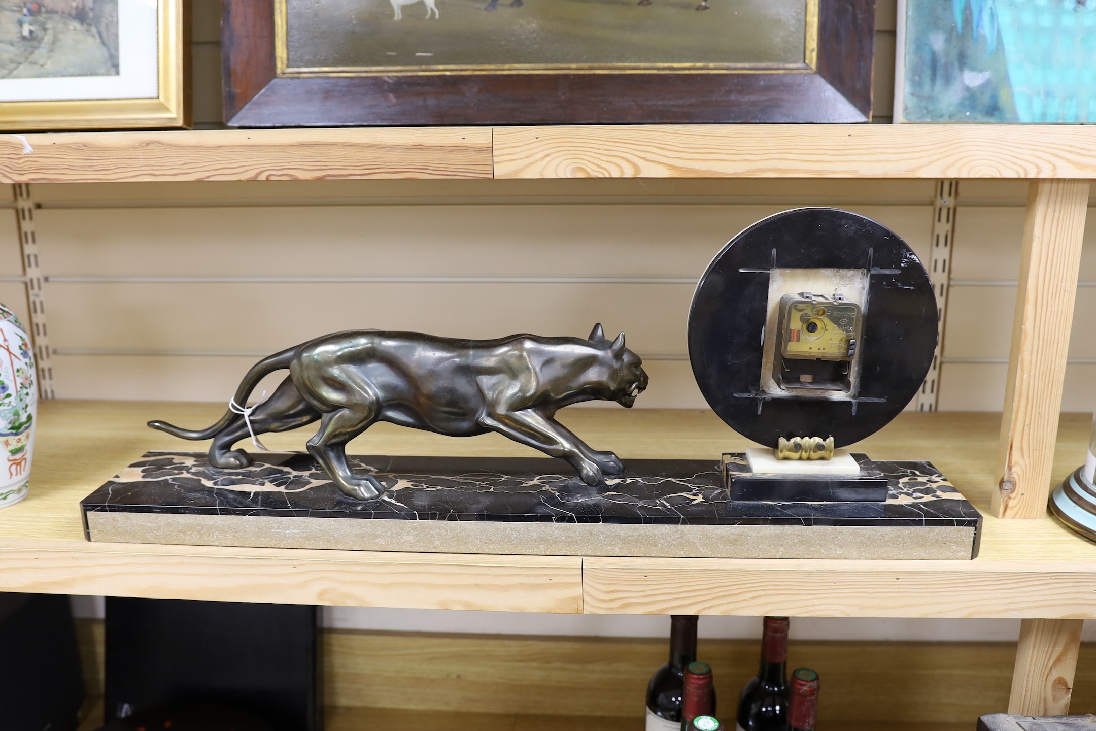 An Deco spelter and marble panther mantel clock on plinth base, 80cm wide